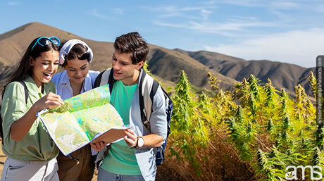 university students with a map in the hills of California